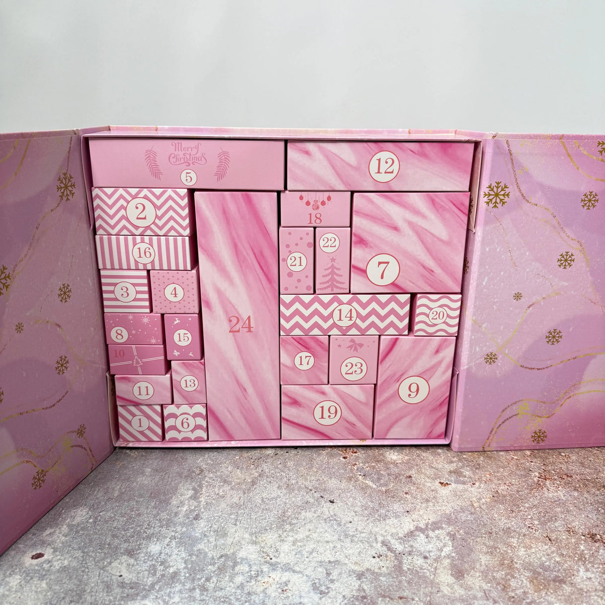 The pink advent calendar box opened, 24 numbered doors