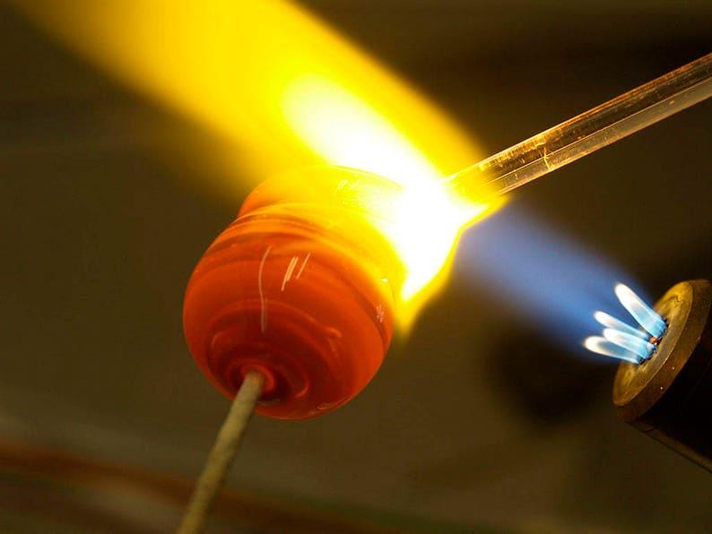 a close up of a piece of metal with a light coming out of it